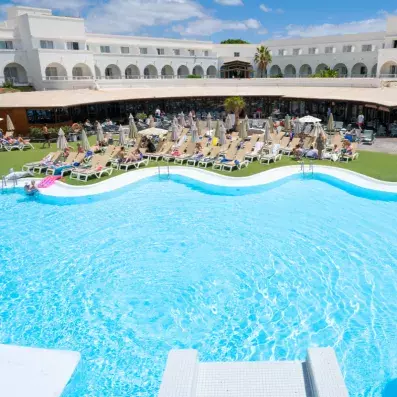 piscine extérieure avec transats et vue de l'hôtel