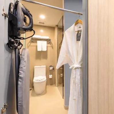 pièce avec un toilette et un peignoir et un aspirateur
