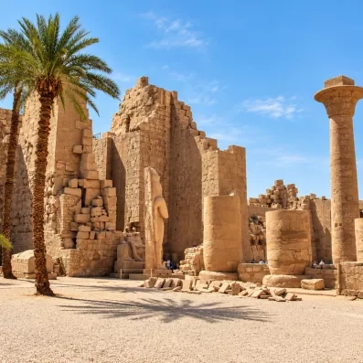 Vestiges antiques et colonnes du temple de Karnak sous un ciel bleu à Louxor, voyage Égypte.
