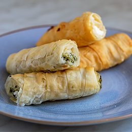 Börek turc feuilleté garni de fromage et d’herbes, spécialité croustillante servie en street food ou au petit-déjeuner.